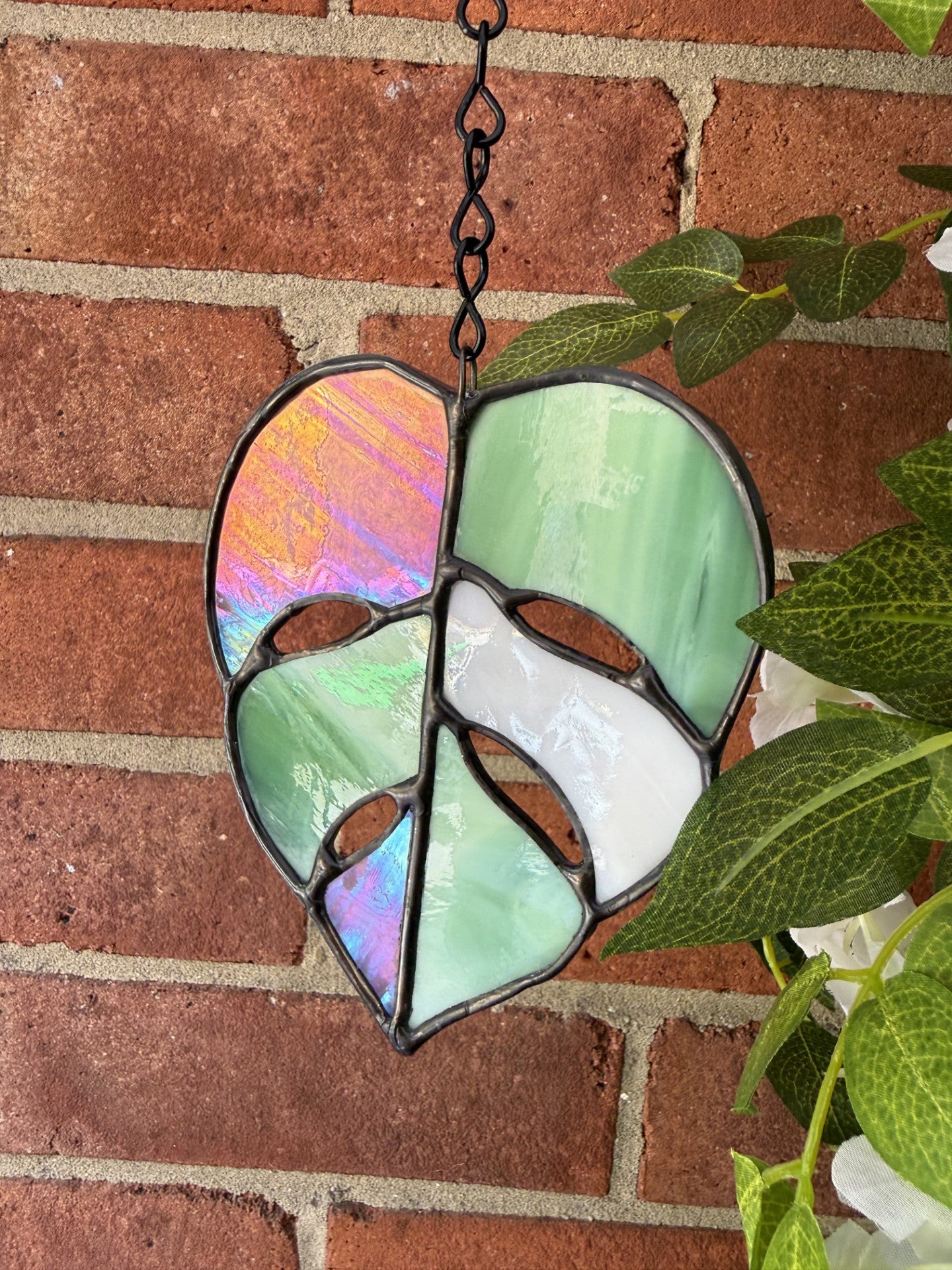 Stained glass monstera leaf suncatcher. Pink, white and green. 